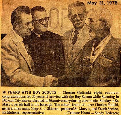 Chester Golinski, right, receives congratulations for 50 years of service with the Boy Scouts while Scouting in Dickson City also celebrated its 5oth anniversary during ceremonies Sunday in St. Mary's parish hall in the borough. The others, from left, are: Charles Malski, general chairman; Msgr. C. J. Sikorski, pastor of St. Mary's, and Frank Srebro, institutional representative.